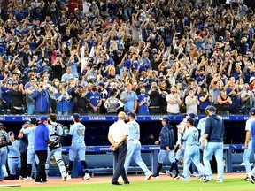 Blue Jays fans applaud their team off the field after a season ending victory over the Orioles at Rogers Centre in Toronto, Sunday, Oct. 3, 2021.