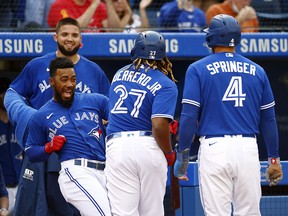 Vladimir Guerrero Jr. of the Toronto Blue Jays celebrates with Teoscar Hernnadez after hitting a two-run home run against the Baltimore Orioles at Rogers Centre on October 2, 2021 in Toronto.