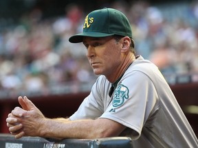 Manager Bob Melvin of the Oakland Athletics watches from the dugout during the interleague MLB game against the Arizona Diamondbacks at Chase Field on June 8, 2012 in Phoenix, Arizona.