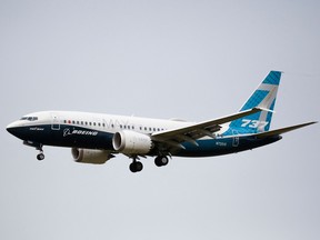 In this file photo taken on September 30, 2020 a Boeing 737 MAX airliner lands following an evaluation flight at Boeing Field the in Seattle, Washington.