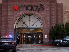 Boise Police Department vehicles sit parked at the scene of a shooting at the Boise Towne Square shopping mall in Boise, Idaho, Oct. 25, 2021.