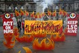 Activists symbolically set George Square on fire with an art installation of faux flames and smoke ahead of the UN Climate Change Conference (COP26), in Glasgow, Scotland, October 28, 2021.