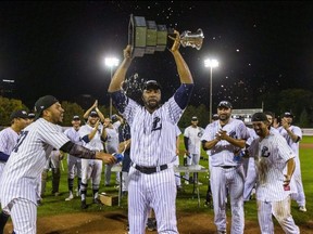 Cleveland Brownlee holds the IBL league championship trophy after the Majors defeating the Toronto Maple Leafs 8-4 in London, Ont. winning their first championship in 46 years. Mike Hensen/Postmedia Network