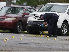 Toronto Police investigate a shooting on Bakersfield St. in North York -- where one man was killed and a second injured -- on Thursday, Oct. 21, 2021.