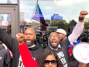 Demonstrators shout slogans outside the Barclays Center  following Brooklyn Nets star Kyrie Irving's refusal to be vaccinated for COVID-19, in New York City, Saturday, Oct. 24, 2021, in this screen grab obtained from a social media video.