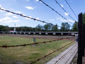 This file photo taken on July 21, 2020 shows barbed wire fence surrounding an area at the former Nazi death camp Stutthof, in Sztutowo, Poland.