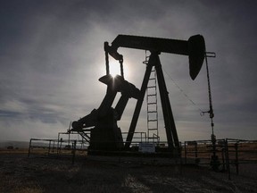 A pumpjack works at a well head on an oil and gas installation near Cremona, Alta., on Oct. 29, 2016.