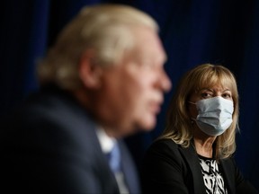 Ontario Minister of Health Christine Elliott looks on at Ontario Premier Doug Ford as he speaks during a press conference at Queen's Park in Toronto, Wednesday, Sept. 22, 2021.