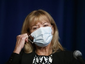 Ontario Minister of Health Christine Elliott removes her mask to speak at a press conference at Queen's Park in Toronto, Wednesday, Sept. 22, 2021.