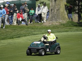 In this June 15, 2012, file photo, Casey Martin drives to the fifth green during the second round of the U.S. Open Championship golf tournament at The Olympic Club in San Francisco.