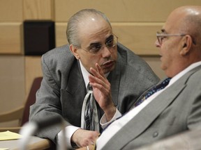 In this Oct. 4, 2013 file photo, defendants Anthony Ferrari, left, and Anthony Moscatiello, right, talk during their trial in Fort Lauderdale, Fla. for murder in the shooting death of Konstantinos "Gus" Boulis, who founded the Miami Subs restaurant chain and owned a fleet of gambling ships. (AP Photo/Lynne Sladky, Pool)