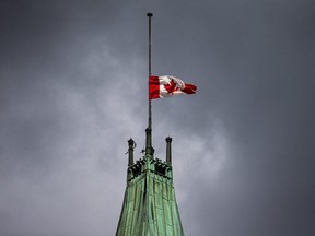 The Canadian flag is seen at half mast above the Peace Tower on Parliament Hill in Ottawa, Sept. 13, 2021.