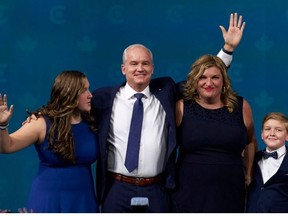 Conservative Leader Erin OToole (2nd L) waves alongside wife Rebecca O'Toole and children -- Jack and Mollie -- on election night in Oshawa,  on Sept. 20, 2021.