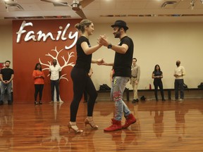 Aleksander Saiyan, director of operations at Toronto Dance Salsa studio in North York, dances with his partner Mariami as they help train his students.