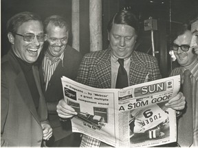 Former publisher Doug Creighton (left) holds the first copy of The Toronto Sun on Nov. 1, 1971 with Ray Biggart (centre) and Peter Worthington and general manager Don Hunt is at left.