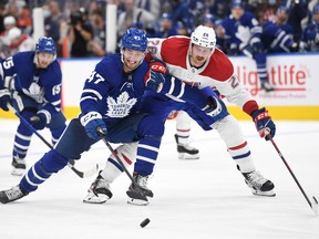 Maple Leafs' Pierre Engvall (left) pursues the puck ahead of Montreal Canadiens' Jeff Petry during the second period at Scotiabank Arena on Wednesday, Oct. 13, 2021.