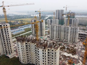 An aerial view shows residential buildings at the construction site of Evergrande Cultural Tourism City, a China Evergrande Group project whose construction has halted, in Suzhou's Taicang, Jiangsu province, China Oct. 22, 2021.