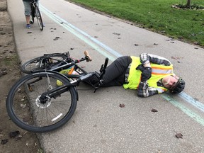 Toronto actor Tedd Dillon is seen on the ground after being knocked off his bike by a dog.