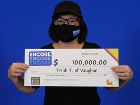 Trinh Tran of Vaughan with her $100,000 winnings from playing Encore on Lotto 6/49.