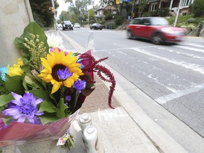 A memorial of flowers and candles were laid near where a 71-year-old man and 69-year-old woman were killed in a multi-car collision on Tuesday afternoon. Toronto Police were at the same intersection at Parkside Dr. and Spring Rd. doing radar  on Wednesday, Oct. 13, 2021.