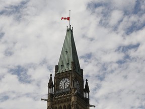 The Canadian flag flies at half-staff on the Peace Tower at Parliament Hill in recognition of the discovery of unmarked indigenous graves at residential schools on Canada Day, July 1, 2021.