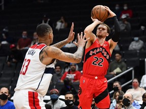 Raptors' Malachi Flynn (right) shoots the ball against Washington Wizards forward Kyle Kuzma during the first half at Capital One Arena on Tuesday, Oct. 12, 2021.