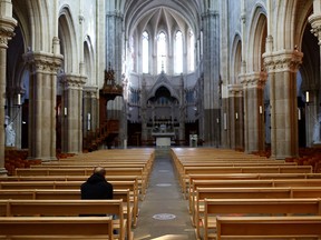 A man prays inside the Saint-Martin church in Vertou near Nantes, France, October 5, 2021.
