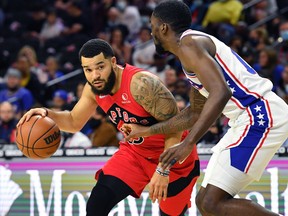 Raptors' Fred VanVleet (left) drives to the basket against Philadelphia 76ers' Shake Milton during the second quarter at Wells Fargo Center on Thursday, Oct. 7, 2021.