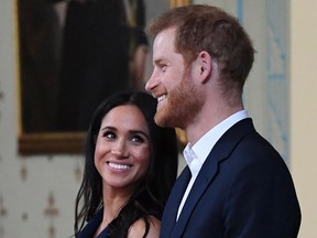 Britain's Prince Harry and Meghan, Duchess of Sussex attend a reception at Government House in Melbourne on October 18, 2018.