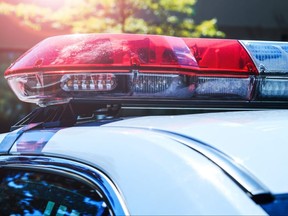 Police force department in full activity. Red light flasher of a patrol police car at sunday. Day patrolling of the city with lights flashers turned off. Security siren of the Canadian police.