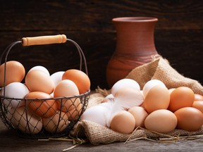 basket of fresh eggs on a wooden table