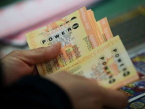 A customer buys Powerball tickets at Kavanagh Liquors on January 13, 2016 in San Lorenzo, California.