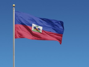 Flag of Haiti in front of a clear blue sky