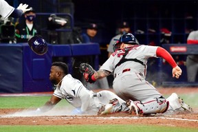 Tampa’s Randy Arozarena steals home against the Boston Red Sox in the seventh inning during Game 1 of the American League Division Series at Tropicana Field on Thursday. GETTY IMAGES