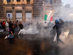 Demonstrators clash with police officers during a protest against the government's introduction of the "Green Pass" near Chigi Palace in Rome, Oct. 9, 2021.