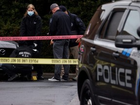 Law enforcement officers collect evidence near the scene of a shooting at the Boise Towne Square shopping mall in Boise, Idaho, Monday, Oct. 25, 2021.