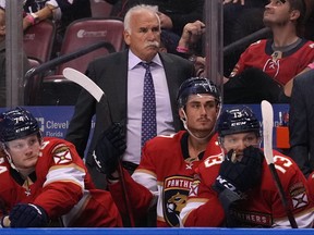 Florida Panthers head coach Joel Quenneville watches from the bench behind his players during the second period against the Boston Bruins at FLA Live Arena in Sunrise, Fla., Oct. 27, 2021.