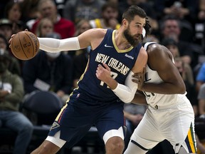 Jonas Valanciunas of the New Orleans Pelicans backs down Hassan Whiteside of the Utah Jazz during their game on October 11, 2021 at the Vivint Smart Home Arena in Salt Lake City, Utah