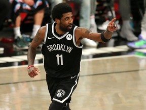 Brooklyn Nets point guard Kyrie Irving reacts after making a basket against the Milwaukee Bucks during the second quarter of game one in the Eastern Conference semifinals of the 2021 NBA Playoffs at Barclays Center in Brooklyn, N.Y., June 5, 2021.