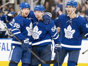 Toronto Maple Leafs left winger Michael Bunting (58) celebrates with defecseman Rasmus Sandin (38) at Scotiabank Arena