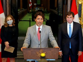 Canadian Prime Minister Justin Trudeau speaks to reporters next to Canadian Deputy Prime Minister and Finance Minister Chrystia Freeland and Minister of Intergovernmental Affairs Dominic LeBlanc on Parliament Hill in Ottawa August 18, 2020.