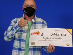 Hughie Gale, of London, Ont., holds his winning Lottario cheque.
