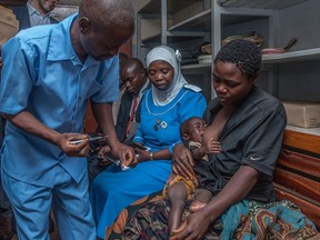 A Health Surveilance Assistant (HAS) prepares to give a dose of the Malaria vaccine to a recipient child on on April 23, 2019 at Mitundu Community hospital in Malawi's capital district of Lilongwe.