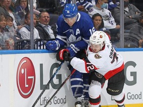 Maple Leafs winger Mitch Marner and Senators defenceman Thomas Chabot fight for the puck on Saturday night. Marner has yet to score a goal this season. GETTY IMAGES