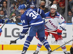 Maple Leafs' Auston Matthews watches an incoming pass while being covered by Mika Zibanejad of the New York Rangers at Scotiabank Arena on Monday, Oct. 18, 2021 in Toronto.