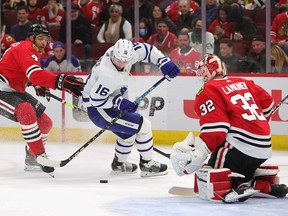 Maple Leafs' Mitch Marner tries to get off a shot against Kevin Lankinen of the Blackhawks under pressure from Seth Jones at the United Center on Wednesday, Oct. 27, 2021 in Chicago.