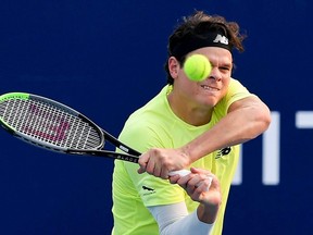 Milos Raonic hits a return during his match against Kwon Soon-woo at the Kooyong Classic in Melbourne, Jan. 14, 2020.