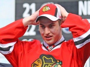 Kyle Beach dons his Blackhawks jersey and hat after being selected at the 2008 NHL entry draft. Beach has come forward as John Doe in the sex-assault scandal engulfing the Blackhawks and the NHL.