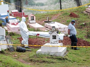 Members of a forensic team carry on a stretcher the remains of victims of the 1989 U.S. invasion after an exhumation at the Monte Esperanza cemetery, in Colon, Panama October 14, 2021.