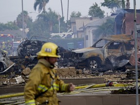 Fire crews work the scene of a small plane crash, Monday, Oct. 11, 2021, in Santee, Calif.